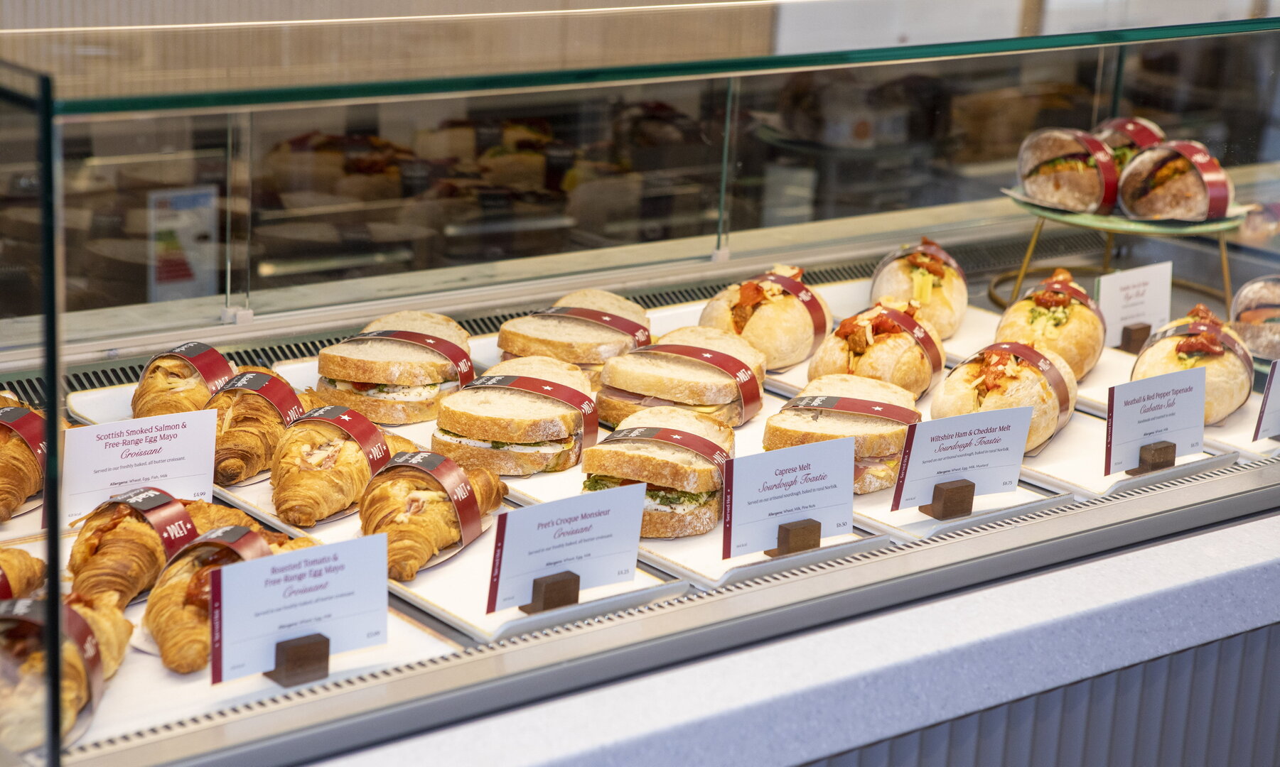 Assortment of sandwiches and croissants in a display case at Pret A Manger.