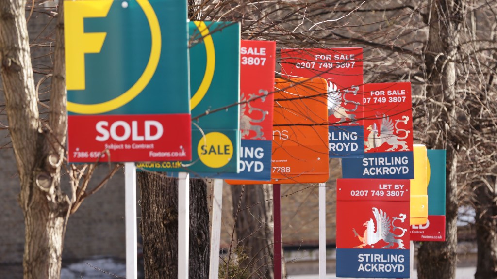 For Sale signs in front of properties.